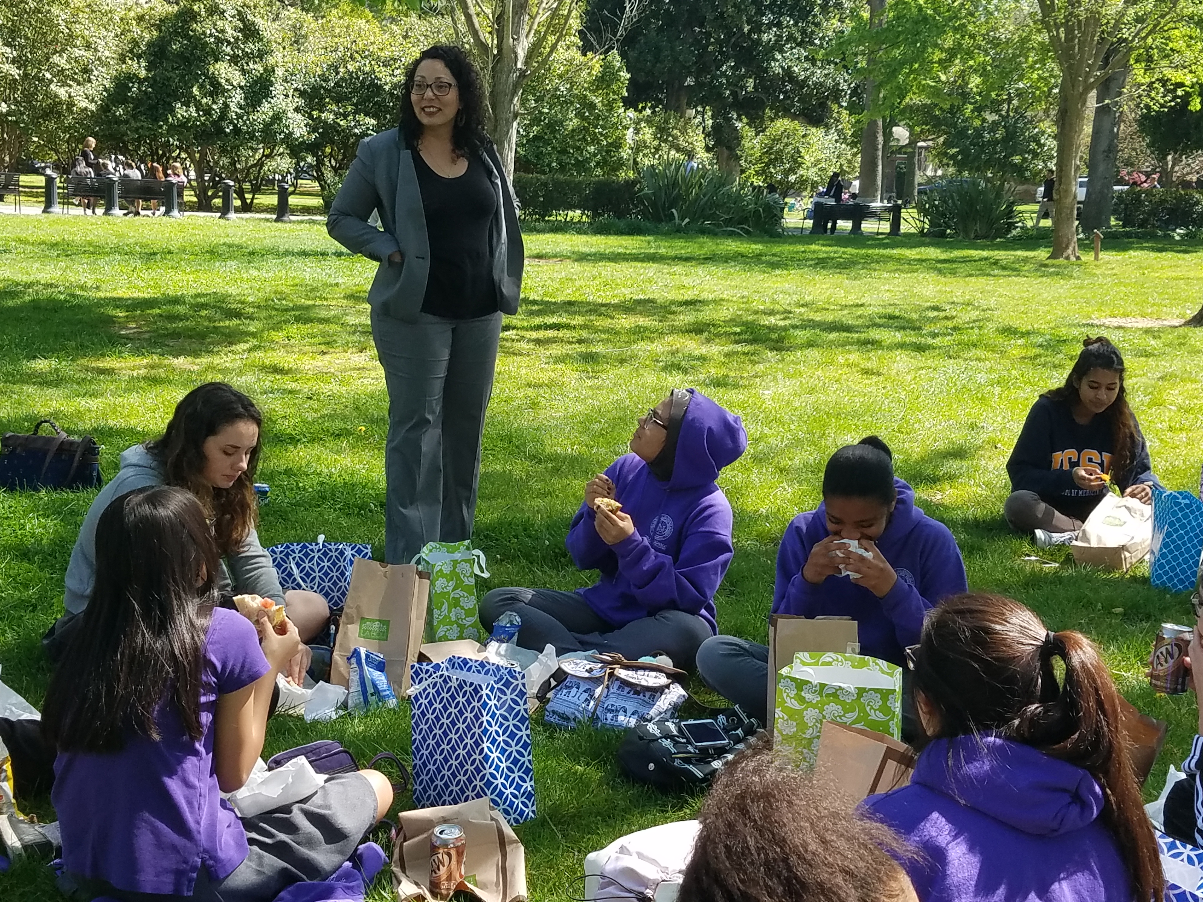 Assemblymember Cristina Garcia talking to the Girls Academic Leadership Academy during their lunch break