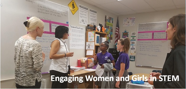 women and girls discussing STEM
